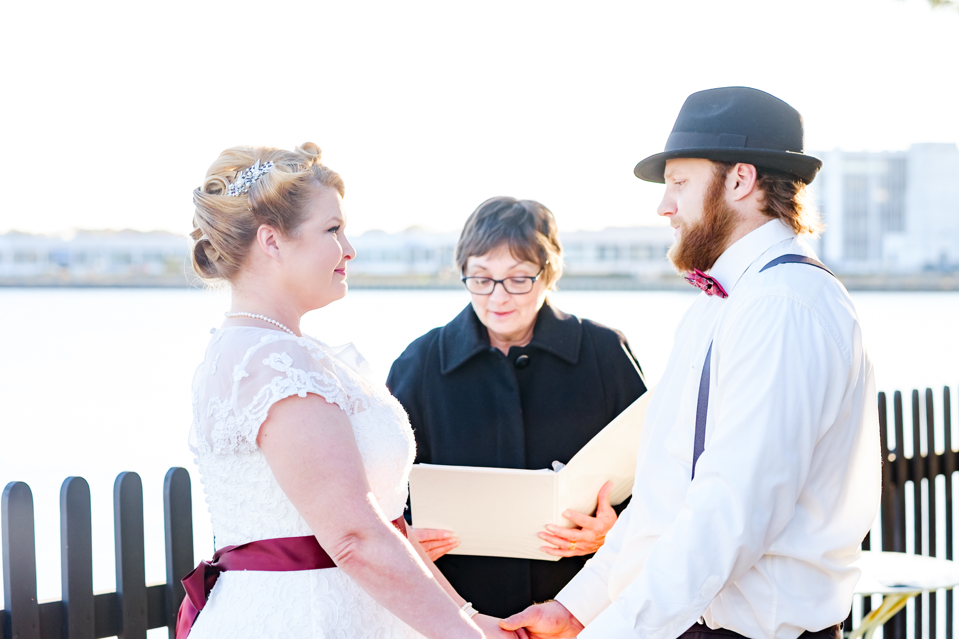 Bride and groom get married in the historic house of the seven gables in salem massachusetts. This elopement has a classic pin up style with a tea length dress, red and black accents, a bow tie, a fedora, and gorgeous curls in her hair. This North Shore elopement was an intimate wedding and it was an honor to be the photographer for this couple.