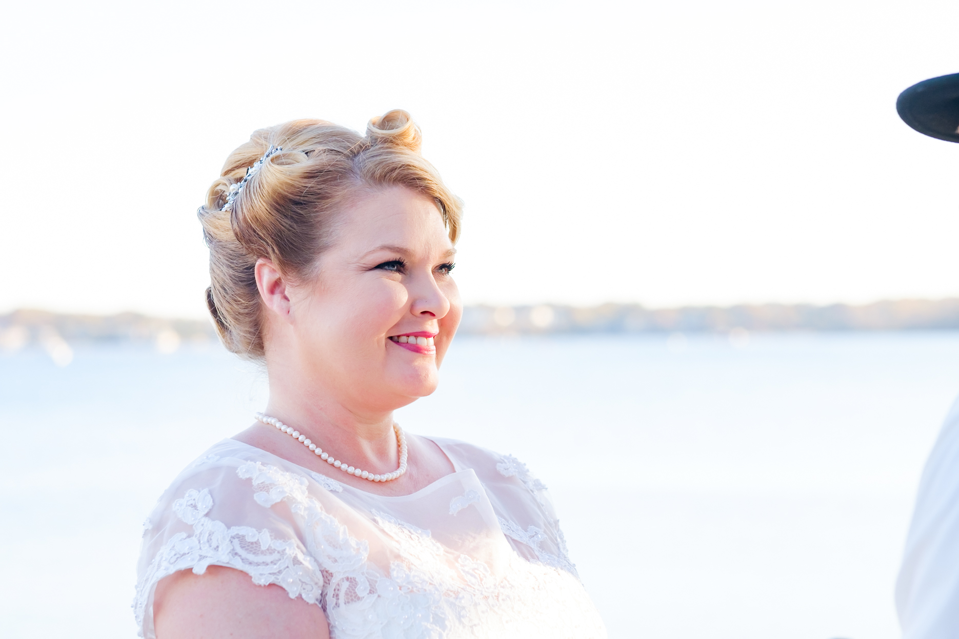 Bride and groom get married in the historic house of the seven gables in salem massachusetts. This elopement has a classic pin up style with a tea length dress, red and black accents, a bow tie, a fedora, and gorgeous curls in her hair. This North Shore elopement was an intimate wedding and it was an honor to be the photographer for this couple.