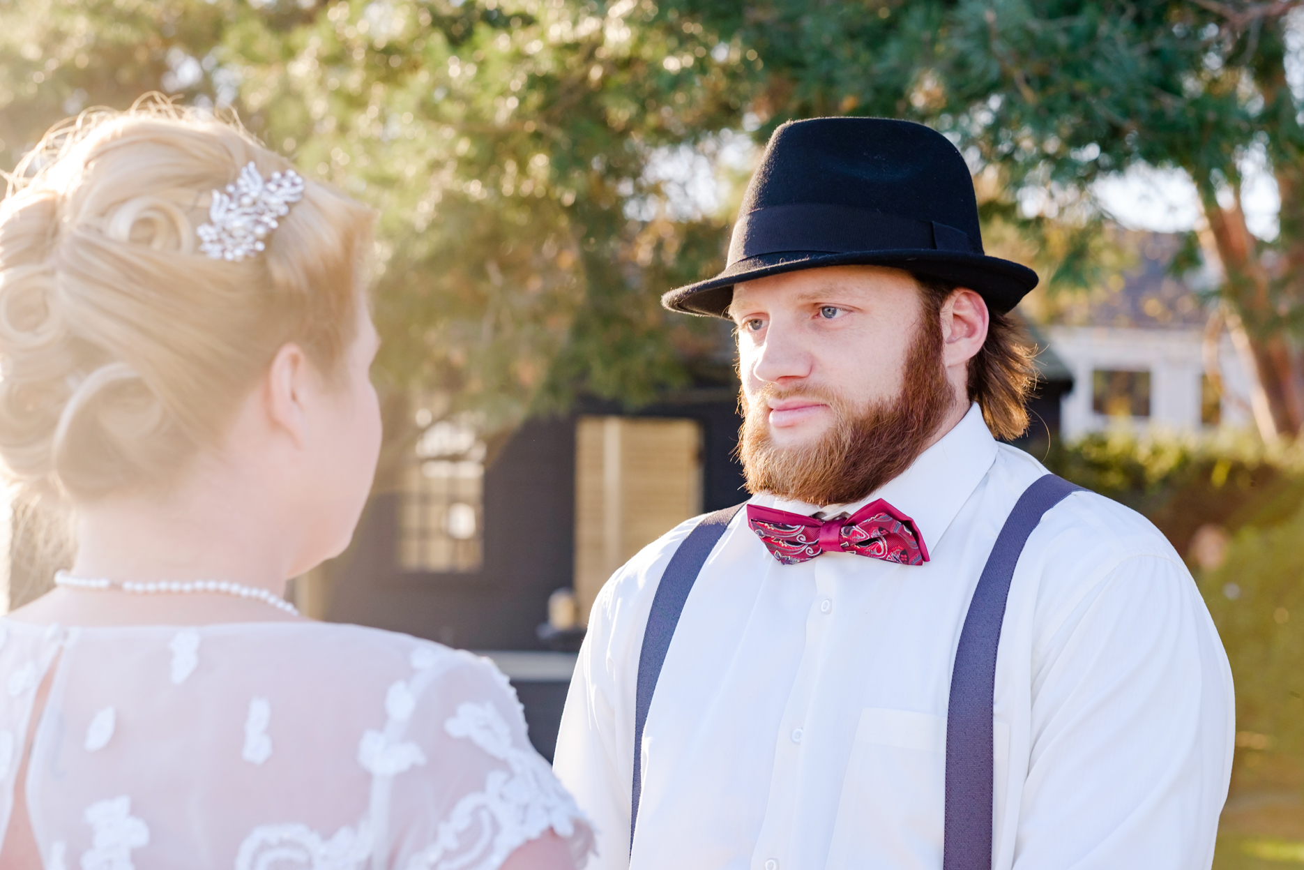 Bride and groom get married in the historic house of the seven gables in salem massachusetts. This elopement has a classic pin up style with a tea length dress, red and black accents, a bow tie, a fedora, and gorgeous curls in her hair. This North Shore elopement was an intimate wedding and it was an honor to be the photographer for this couple.