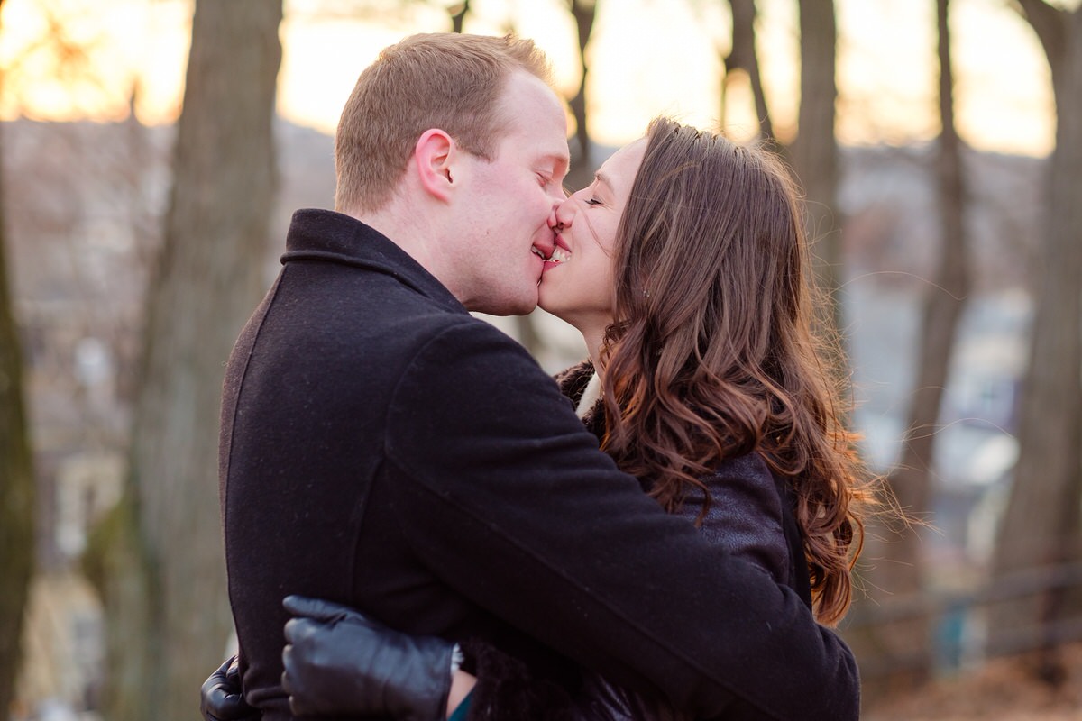 Engaged couple kissing in winter in Prospect Hill Park