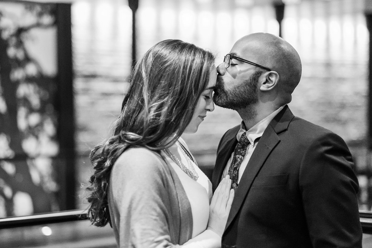 Man kisses a woman on the forehead in the Liberty Hotel in Boston