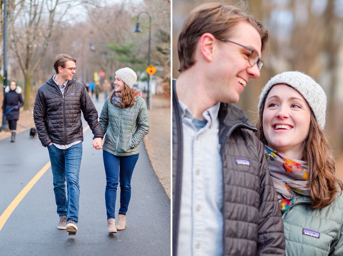 Engaged couple in Patagonia coats walks down the Davis Square bike path during an engagement photo session