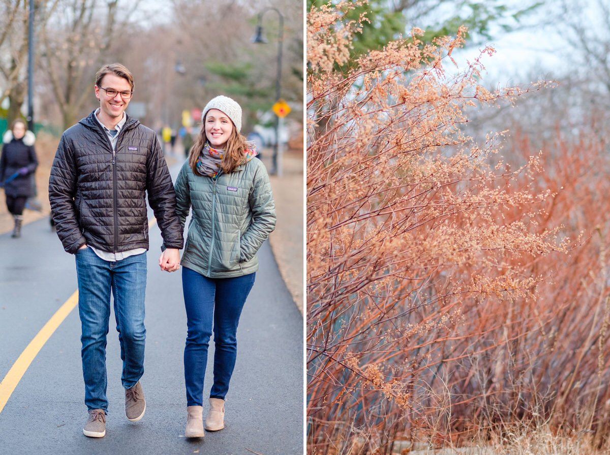 Engaged couple in Patagonia coats walks down the Davis Square bike path during an engagement photo session