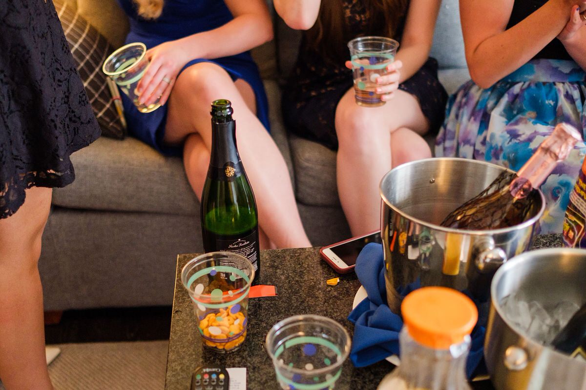 Friends of the bride drink champagne and eat Goldfish