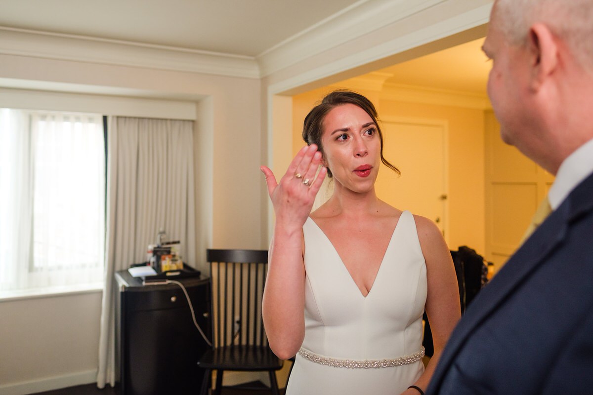 Bride waves away tears in an emotional first look with her day