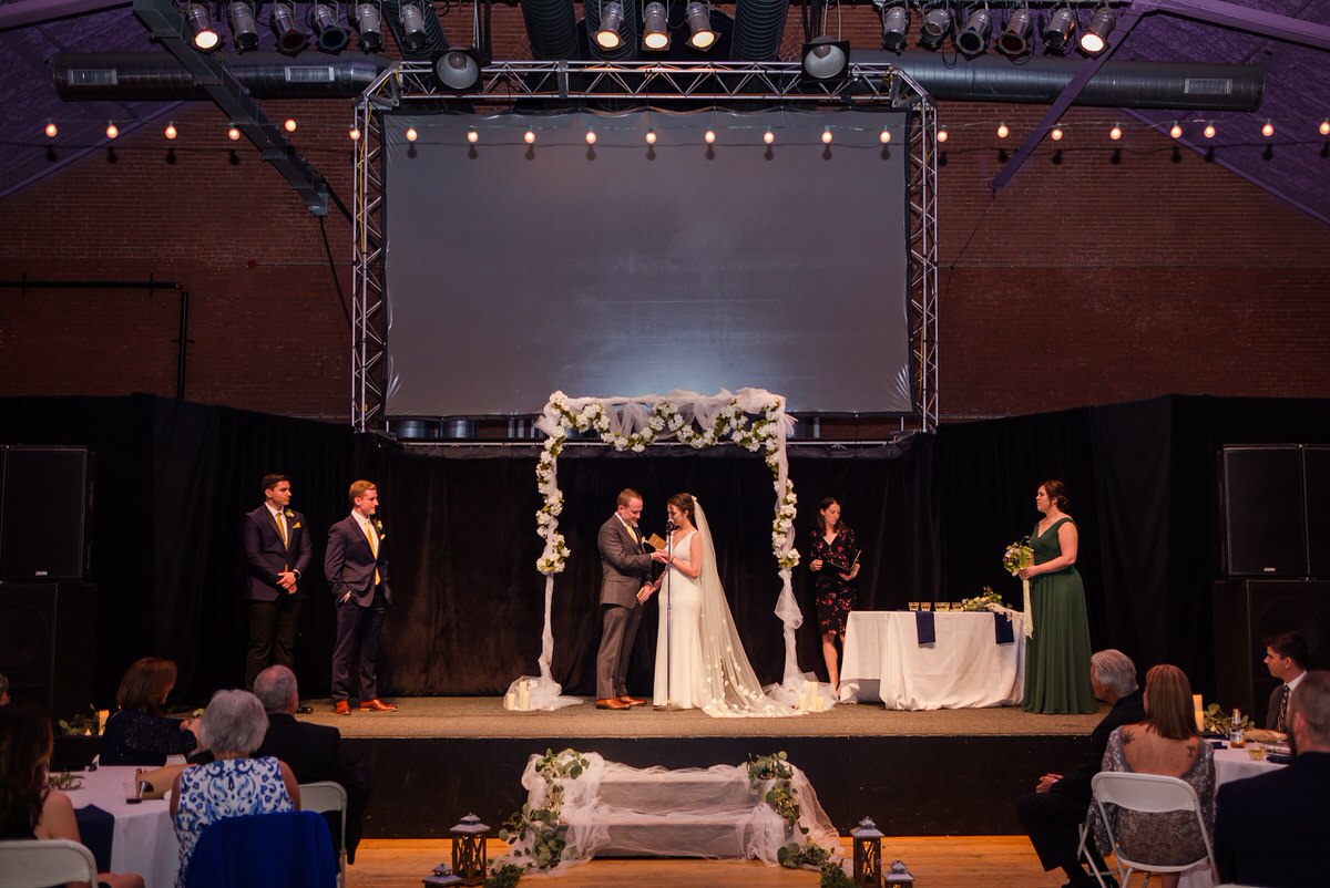 Wide shot of wedding ceremony at the Somerville Armory