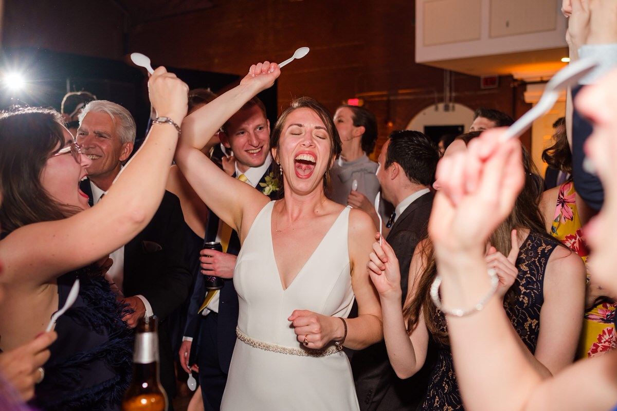 Bride and her friends dance with plastic spoons as a sorority tradition