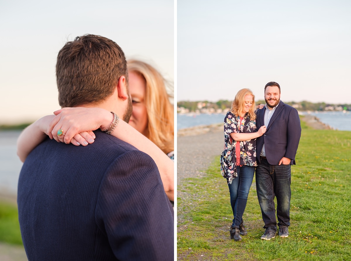 Man in a navy suit jacket walks alongside his blonde fiance in a floral shawl at the historic Salem waterfront