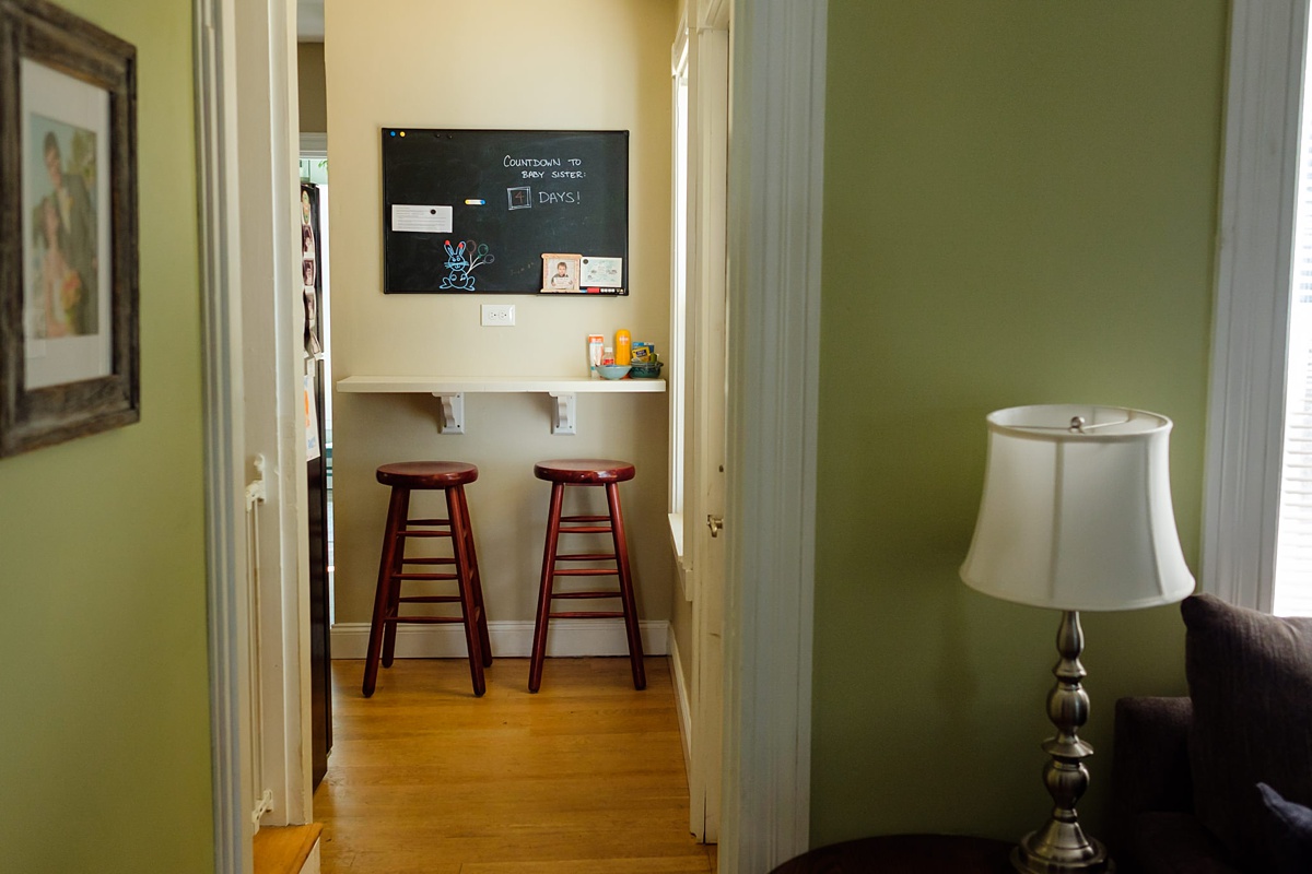 Green kitchen hallway with newborn countdown