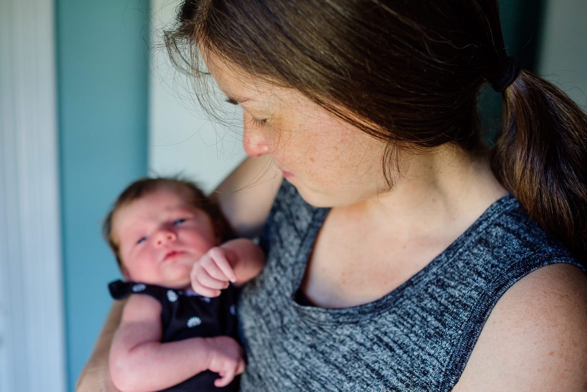 Mom looks down on her newborn baby girl