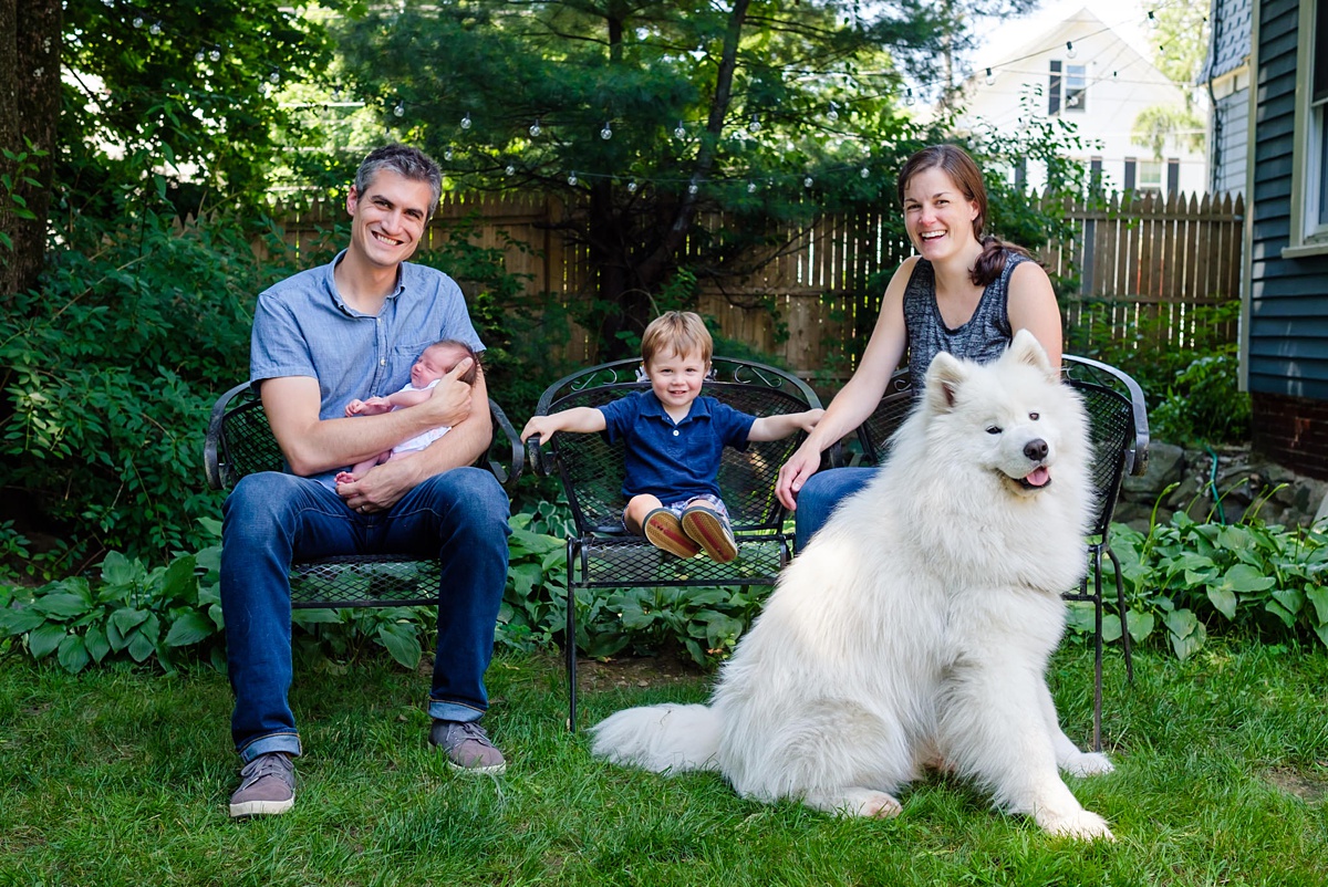 Sweet family of four in blue poses for the camera