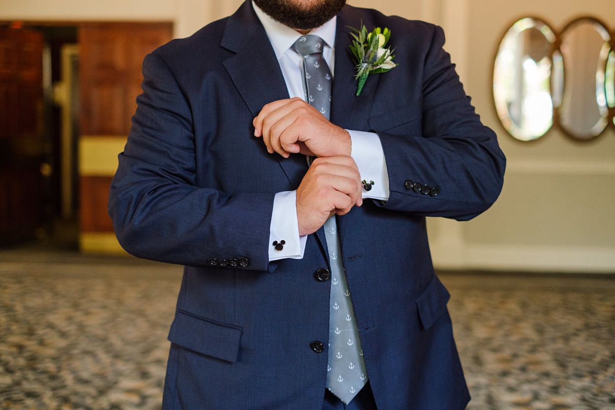 Groom adjusts his cufflinks in the ballroom of the Hawthorne Hotel in Salem, MA