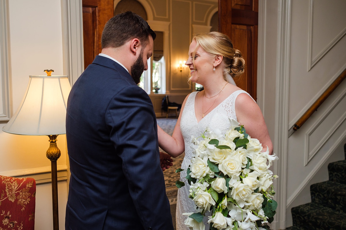 Bride and groom's first look in the lobby of the Hawthorne Hotel in Salem, MA