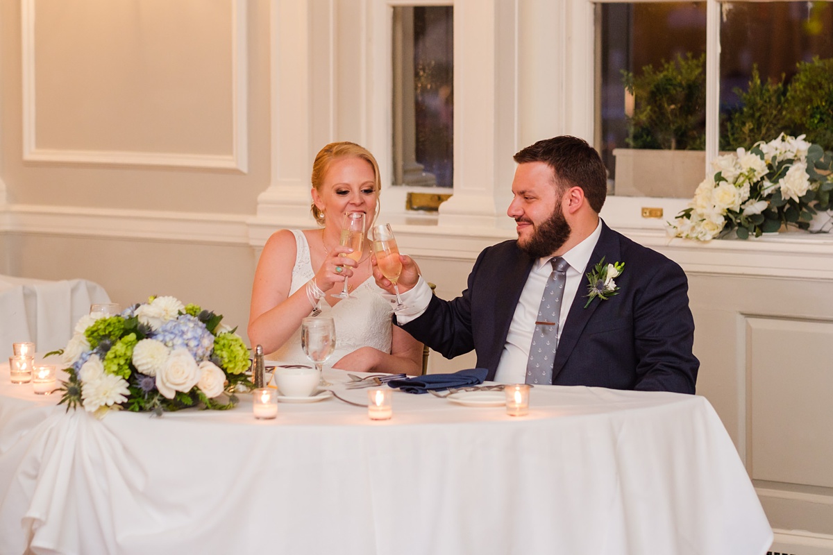 Newlyweds clink glasses during Hawthorne Hotel wedding toasts