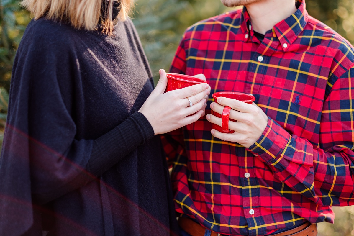 Holiday Christmas Tree Farm Engagement Session clinking mugs