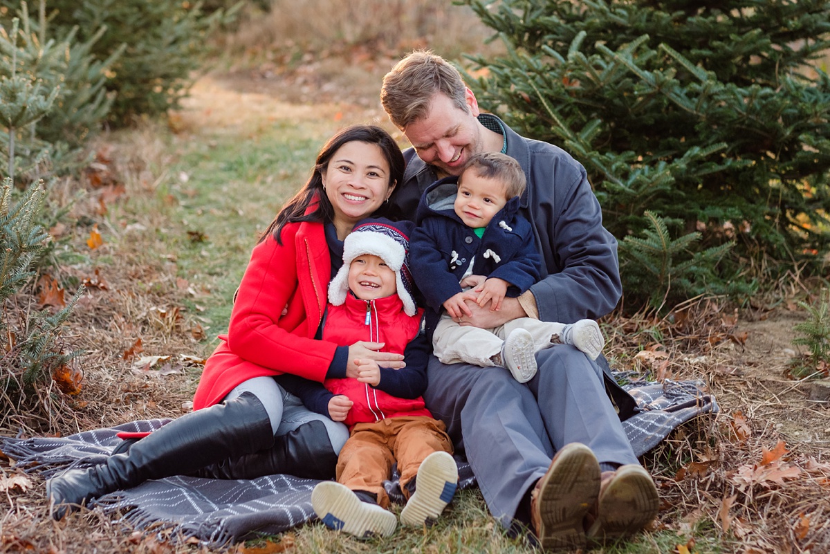 North Shore Christmas tree farm photo of family cuddling and laughing on a blanket