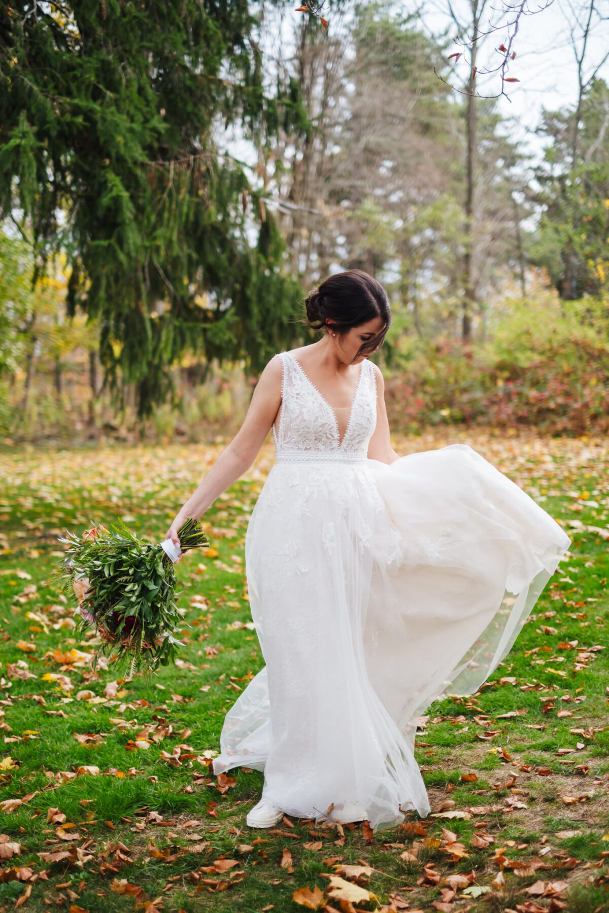 Bride twirls her dress in the woods